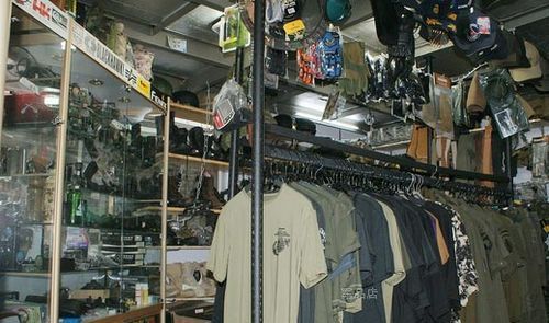 Owner of a military store, what is the name of a store that sells military clothing? Picture 3